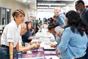 adults at a check in table